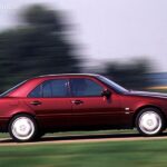 Front three-quarter view of a 1998 Mercedes-Benz C280 sedan in silver, parked on a paved surface, showcasing its classic design