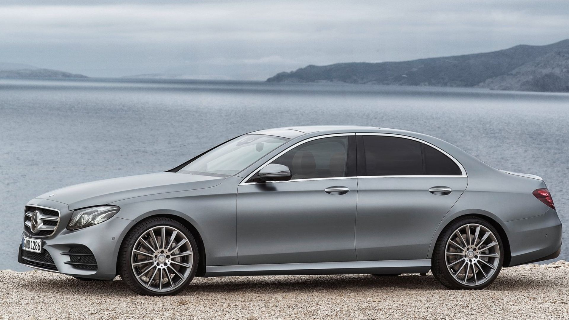 Grey 2017 Mercedes-Benz E-Class elegantly cruising, highlighting its sophisticated sedan design.