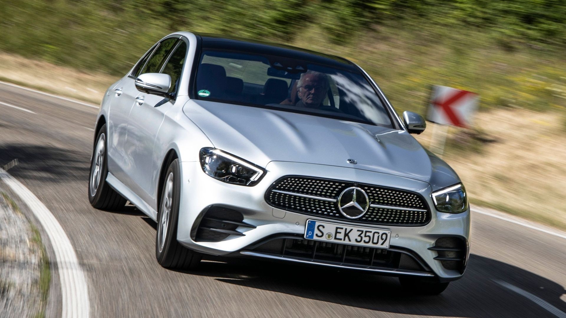 Silver 2022 Mercedes-Benz E-Class parked in an urban setting, highlighting its facelifted modern design.