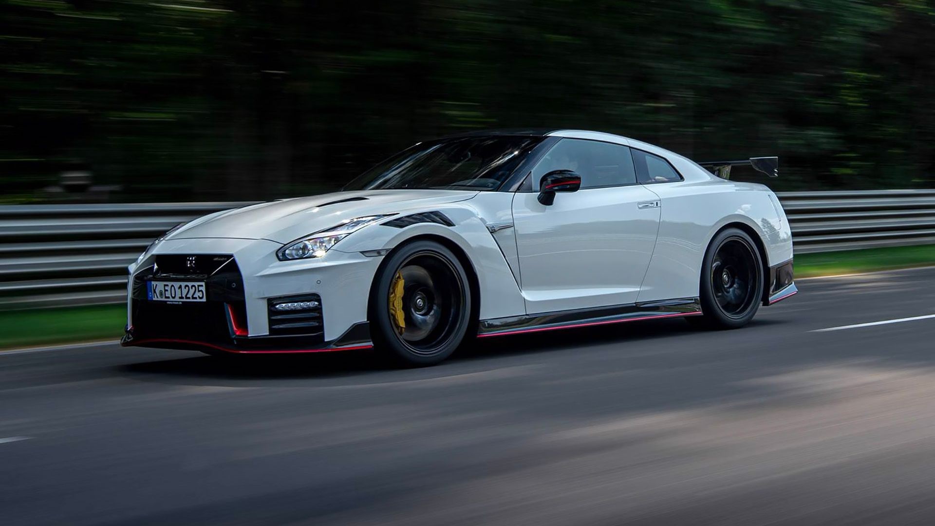 A Nissan GT-R NISMO car in red, displayed at an angle to highlight its sporty features and design, showcasing a modern classic car