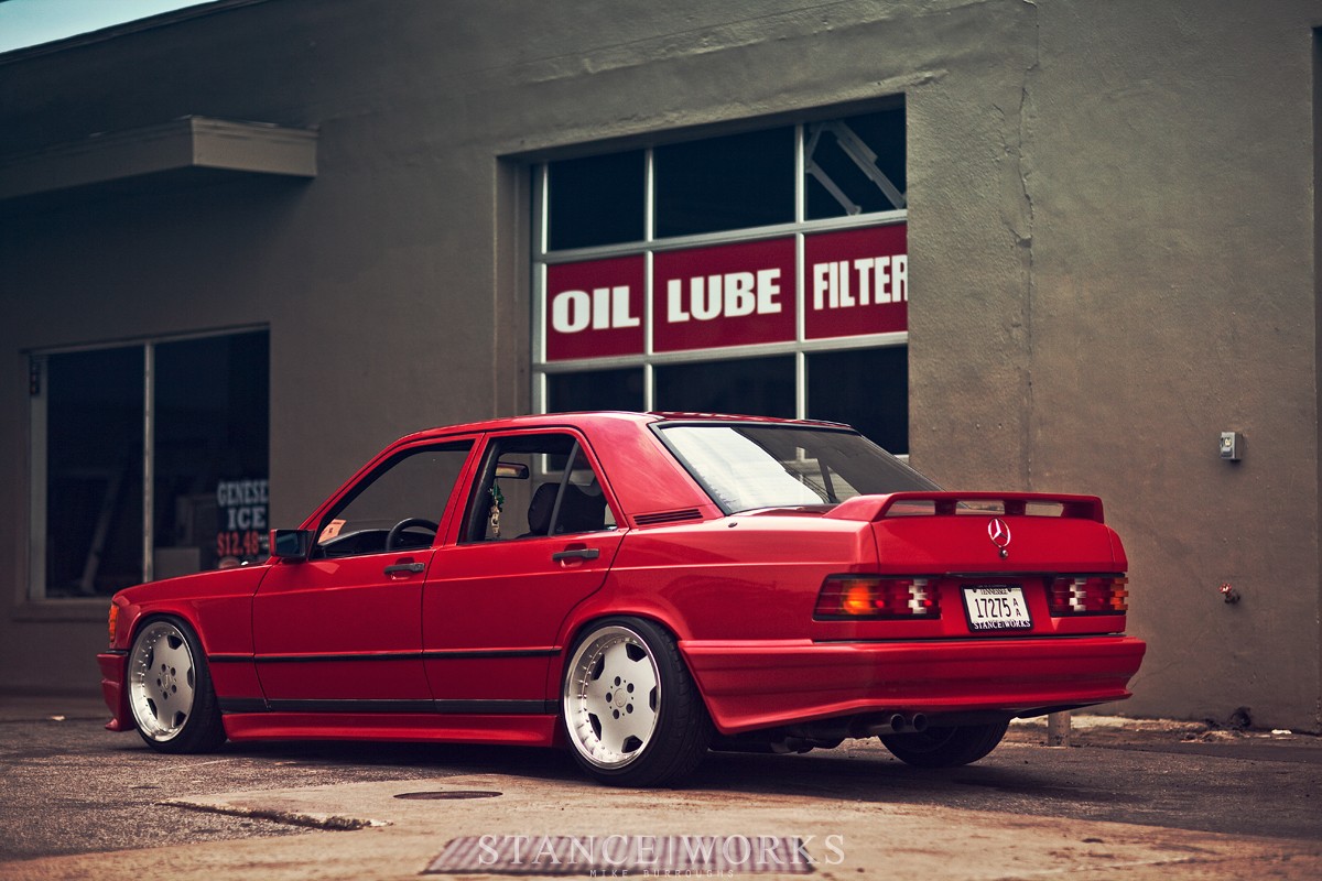 Mercedes-Benz 190E Cosworth Evolution model parked outdoors, showcasing its boxy silhouette and sporty stance, emphasizing its heritage and performance lineage.