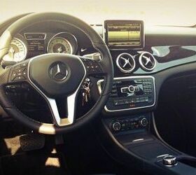 Front three quarter view of a red 2014 Mercedes Benz CLA 250 4Matic showing its coupe like styling