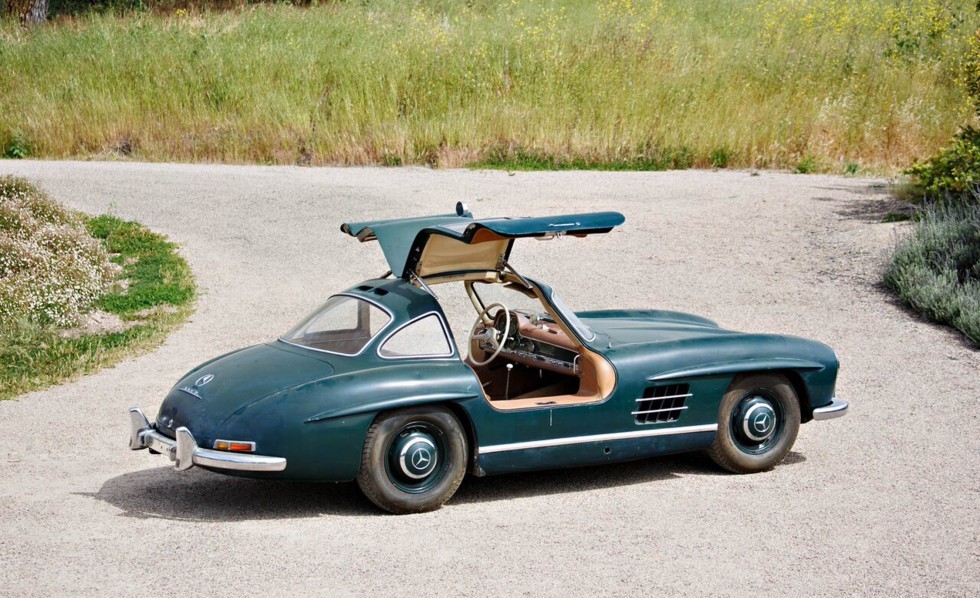 Classic 1950s Mercedes-Benz 300SL Gullwing and Roadster models showcased before auction, highlighting vintage car appeal for collectors