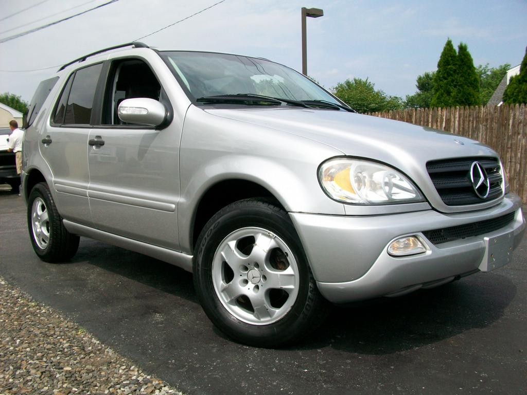 Silver 2002 Mercedes-Benz ML320 SUV parked on a street, showcasing its refreshed design.