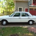 Front view of a white 1983 Mercedes-Benz 240D, a classic diesel sedan known for its durability.