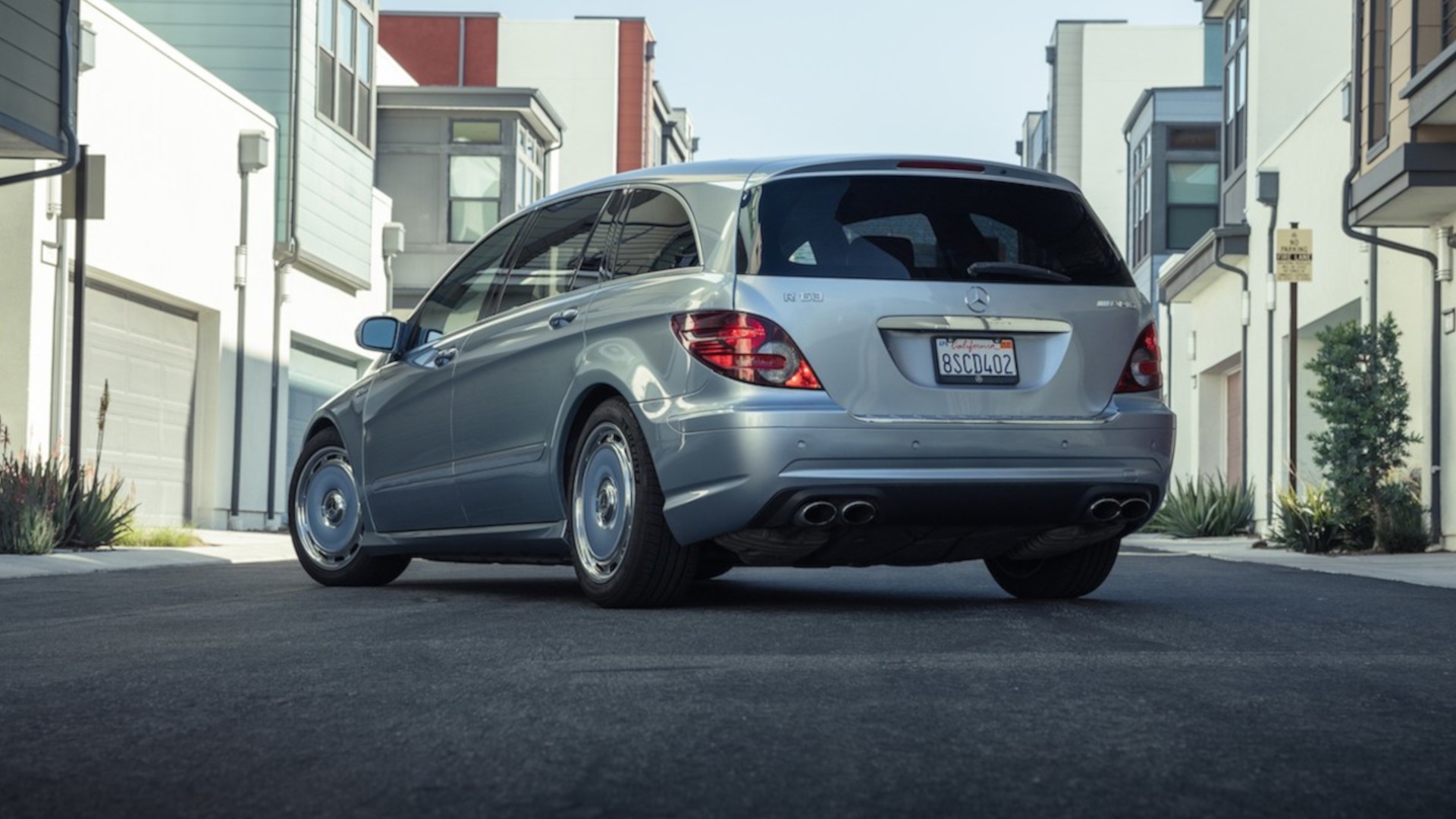 rear three-quarter view of a black Mercedes-Benz CLK 63 AMG Convertible with AMG quad exhaust pipes